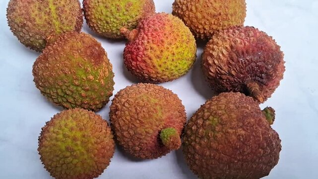 Lychee fruits on a white marble background 