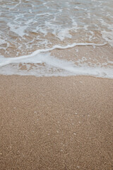 Foam waves on white sand on the beach