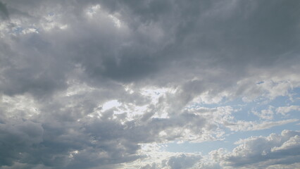 Obraz premium A Dramatic and Beautiful Cloudy Sky with Sunlight Gently Breaking Through the Clouds Above