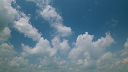 Time lapse. The Beautiful Blue Sky is adorned with Fluffy White Clouds, creating a stunning view