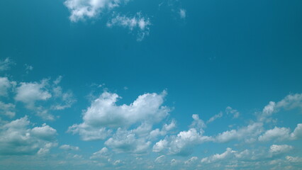 Time lapse. A Beautiful Serene Blue Sky with Fluffy White Clouds Captured in Natures Tranquil Calm