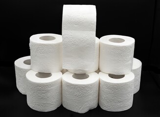 Stack of White Toilet Paper Rolls on Dark Surface – Clean and Minimal Style. Hygiene and Supply Concept