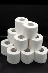 Stack of White Toilet Paper Rolls on Dark Surface – Clean and Minimal Style. Hygiene and Supply Concept