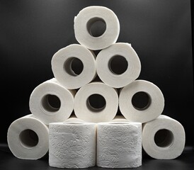 Stack of White Toilet Paper Rolls on Dark Surface – Clean and Minimal Style. Hygiene and Supply...