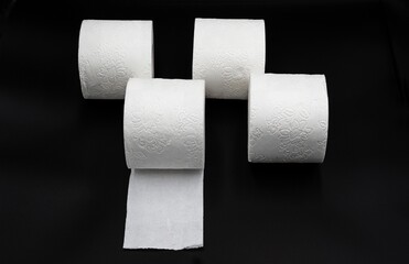 Stack of White Toilet Paper Rolls on Dark Surface – Clean and Minimal Style. Hygiene and Supply Concept
