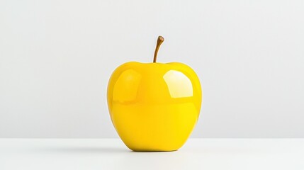 A brightly colored yellow apple with a brown stem is shown