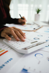 Businessman reviews business infographic on clipboard, analyzing bar and line charts surrounded by...