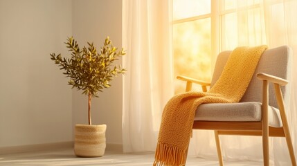 A comfortable armchair and decorative plant with warm sunlight coming through