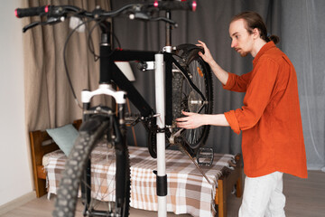 young man working repairing bike at home