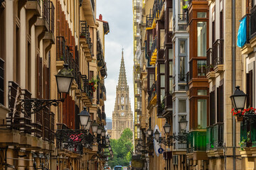 Obraz premium Main street in the old town of San Sebastian with the cathedral of the Good Shepherd in the background, Basque Country.