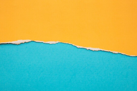 Yellow ripped paper torn edges strips isolated on blue background