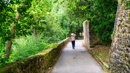 Tourist woman walking along the walls of the castle of La Mota on Mount Urgull, San Sebastian.