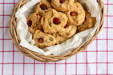top view, Homemade Healthy Cereal Cookies with almond top in container woven