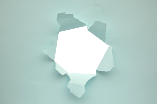 Torn ripped blue paper hole isolated on white background