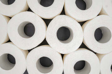 Stack of White Toilet Paper Rolls on Dark Surface – Clean and Minimal Style. Hygiene and Supply...