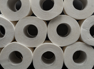 Stack of White Toilet Paper Rolls on Dark Surface – Clean and Minimal Style. Hygiene and Supply...