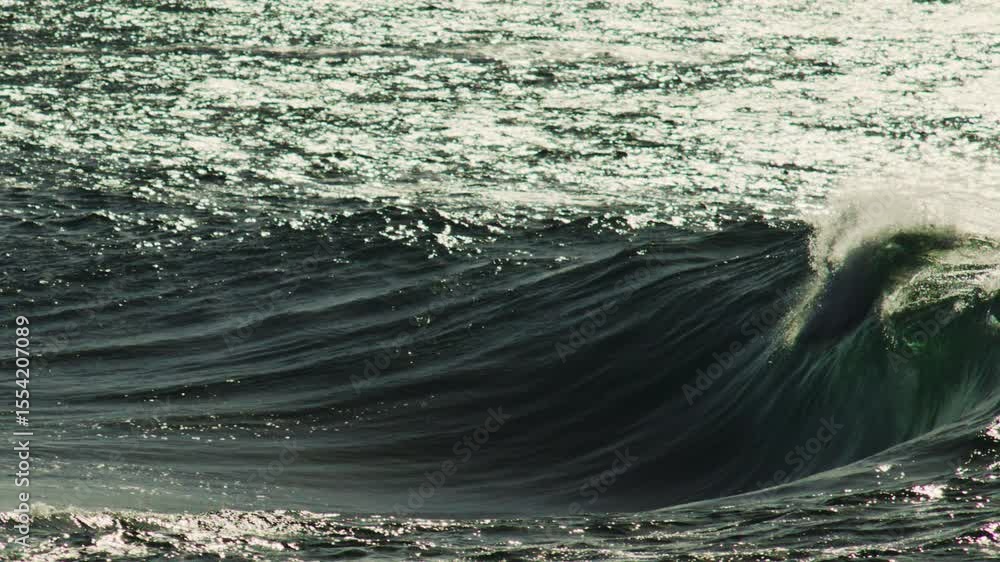 Poster sunlit crest of wave curls with glowing green hue as foam and mist burst into warm light