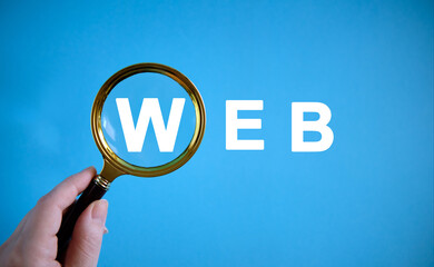 WEB - text with a magnifying glass on a blue background