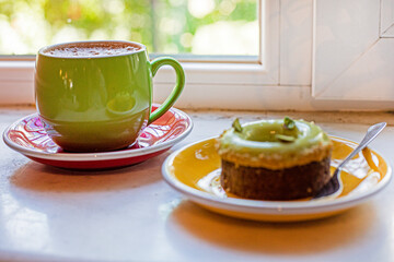 cup of hot chocolate with a dessert Dubai tart with pistachio cream,