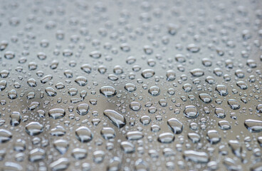 Water droplets on a metal surface. Drops of water on a metal surface.