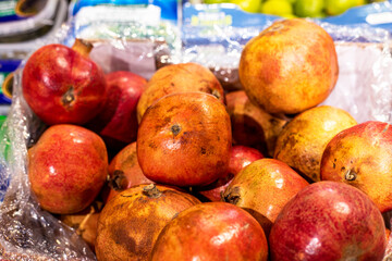 ripe red pomegranates in a container in a supermarket. Natural Increase in hemoglobin in the blood