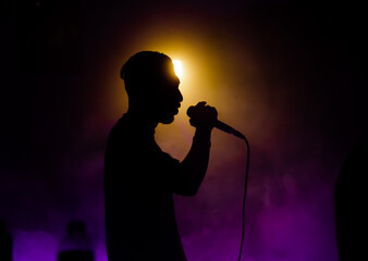 low light Rappers in purple smoke