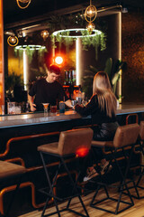 Casual Evening Bar Interaction with Stylish Interior Lighting and Design