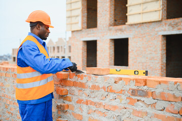 African american Construction worker in uniform and safety equipment have job on building....