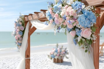 Wooden pergola on beach with flowers and fabric decorations