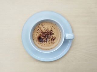 Cappucino coffe in glass on wooden table background, Flat lay