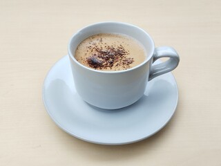 Cappucino coffe in glass on wooden table background, high angle view 