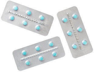 Blue pills in the plastic blister, isolated on white background, top view.
