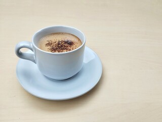 Cappucino coffe in glass on wooden table background. High angle view, Copy space 