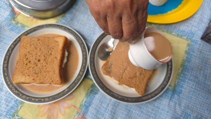 Viral Dubai chai toast trending on internet, freshly made with bread filled with malai milk cream, soaked in hot spiced tea. A nostalgic and viral comfort food