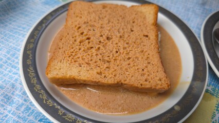 Viral Dubai chai toast trending on internet, freshly made with bread filled with malai milk cream, soaked in hot spiced tea. A nostalgic and viral comfort food