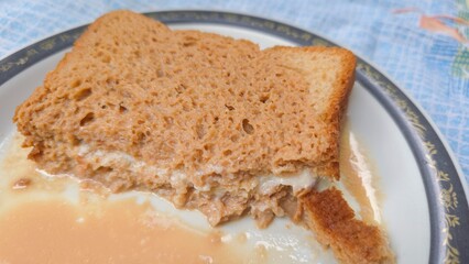 Viral Dubai chai toast trending on internet, freshly made with bread filled with malai milk cream, soaked in hot spiced tea. A nostalgic and viral comfort food