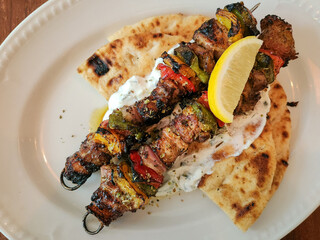 A close-up photo of a Greek Pork Souvlaki meal.