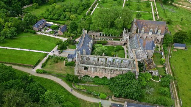 Slow panning drone movement near the gothic Abbaye de Beauport abbey as historical monument, Paimpol, Brittany, France.