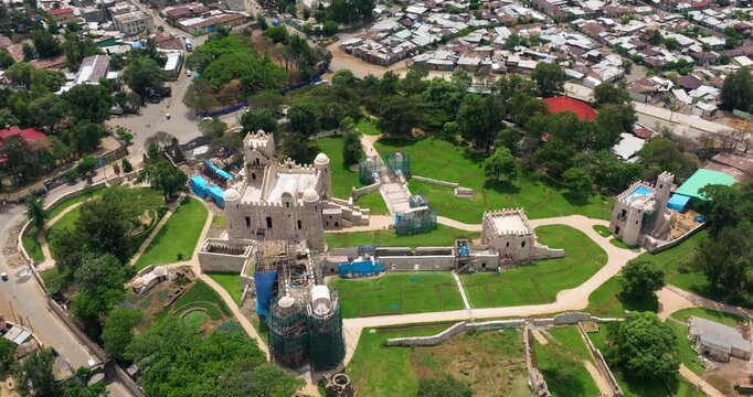 Fasil Ghebbi Fortress Under Renovation In Gondar, Amhara Region, Ethiopia. aerial ascending shot