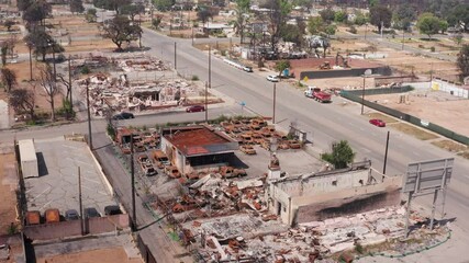 Aerial descending close-up shot of burned cars at the Altadena Auto Center on Fair Oaks Ave. after the Eaton Fire in Southern California. 4K