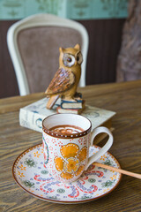 High Angle View Of Coffee Cup On Wooden Table In Vintage Cafe. 