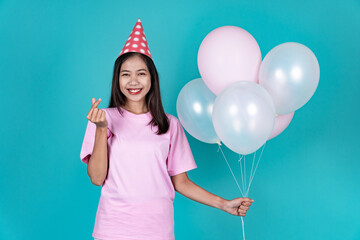 Portrait of Cheerful Young Asian Woman Celebrating Birthday And Finger Gesture

