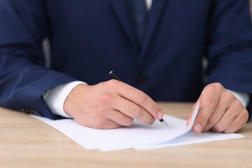 Judge working at wooden desk indoors, closeup