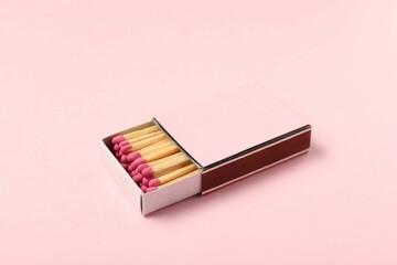 Matches in box on pink background, closeup. Mockup for design
