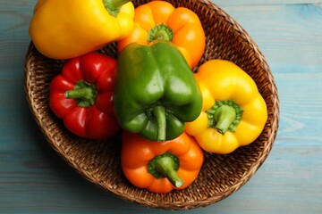 Fresh colorful bell peppers on blue wooden table, top view