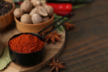 Different aromatic spices on wooden table, closeup. Space for text
