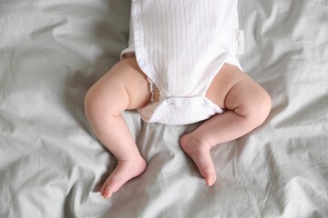 Cute newborn baby lying on bed, top view