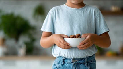 A young child is holding a bowl of delicious snacks in a cozy kitchen, reflecting the warmth of home life and the simple pleasures of childhood and family bonds.