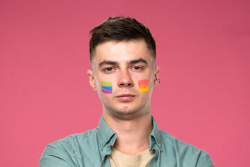 Man with Colorful Face Paint on Pink Background Celebrating Diversity