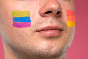 Face with colorful paint stripes symbolizing pride and diversity